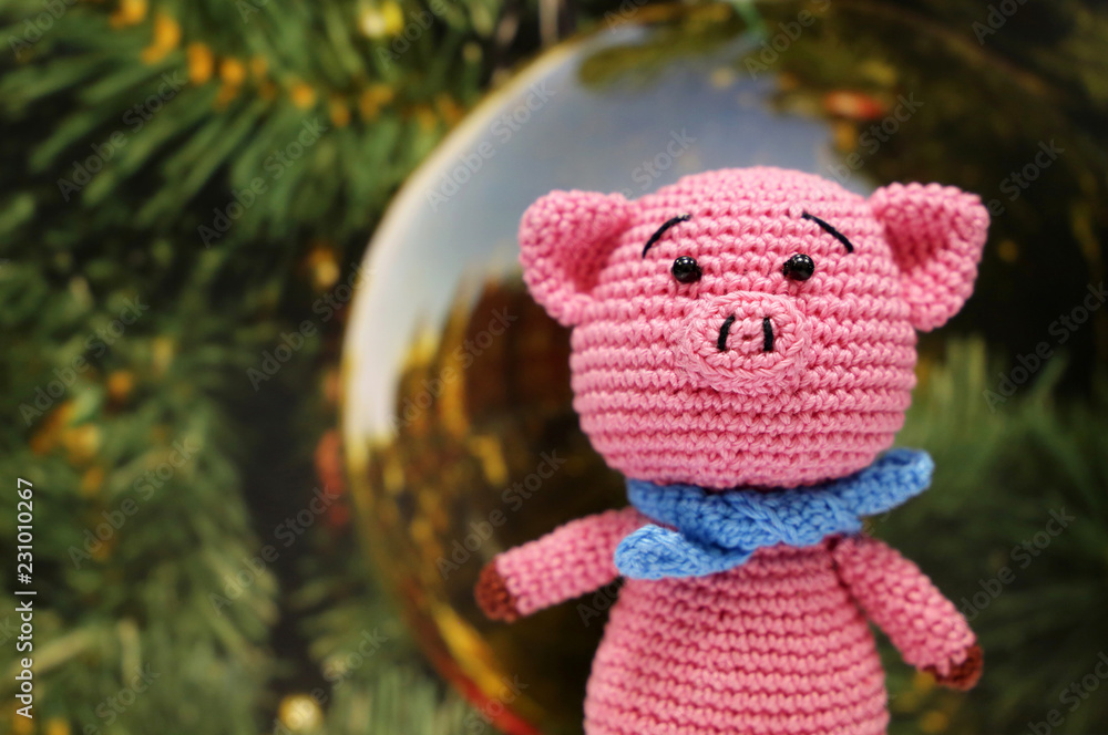 New Year of Pig on christmas decorations background. Festive card with knitted toy pig, Chinese Zodiac symbol 2019