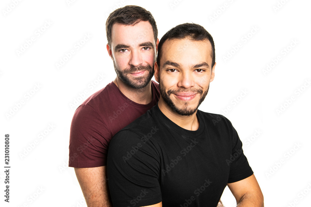 Young homosexuals gay couple love each other on a white background. Young homosexuals gay couple love each other on a white background.