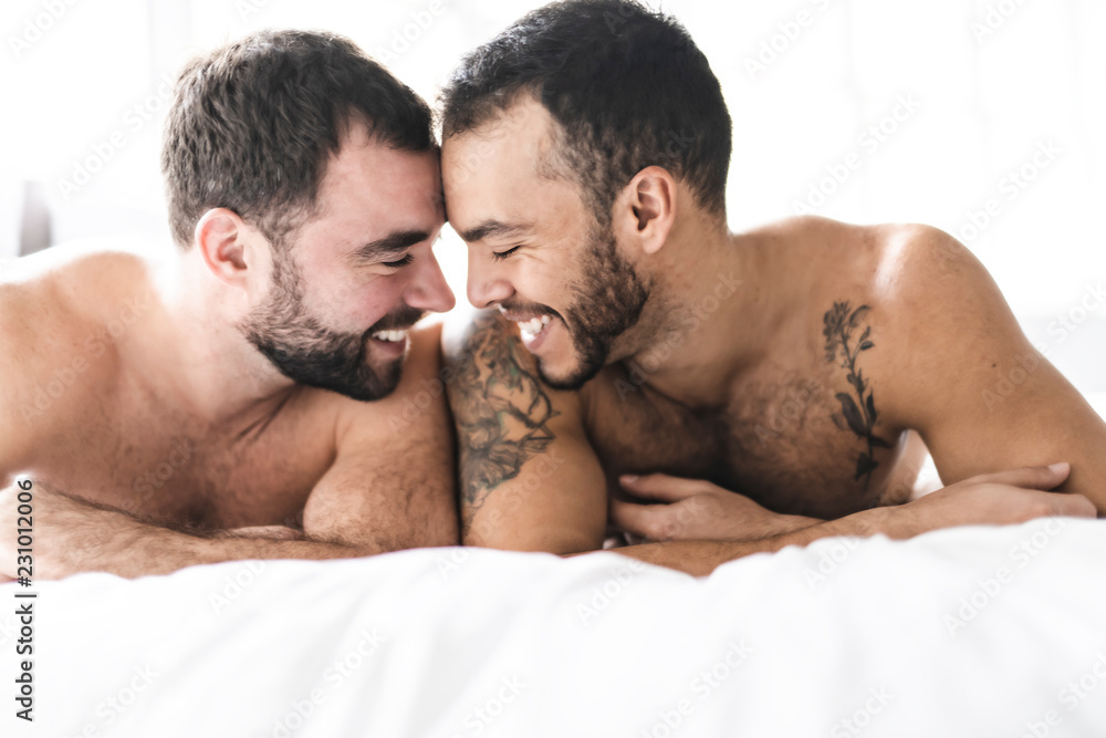Fototapeta premium A Handsome gay men couple on bed together