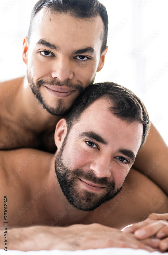 Foto Stock A Handsome gay men couple on bed together | Adobe Stock