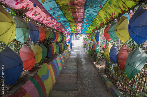 Rainbow of colors at this entrance to the Malang Jodipan slum village through an alley of colorful umbrellas in Java, Indonesia