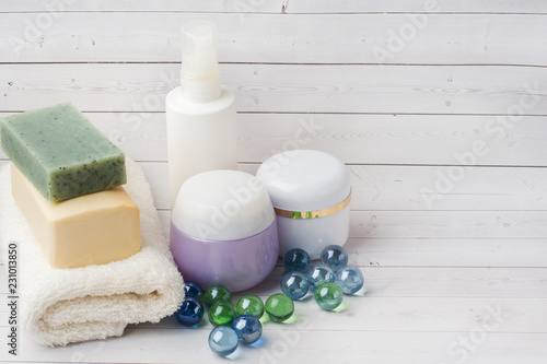Spa and Wellness concept on white background. Towels cream soap and bath accessories. Copy space