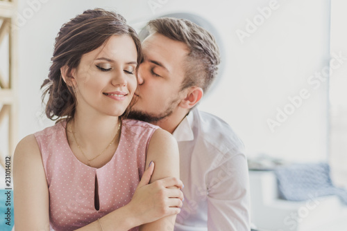 young guy kissing girl on the cheek, happy couple in love, love, Valentine's day