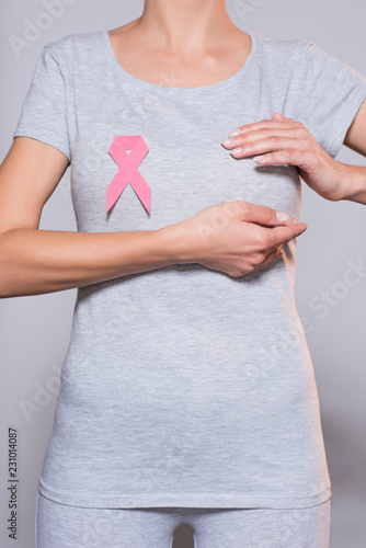 Wallpaper Mural cropped shot of woman with breast cancer awareness pink ribbon on grey background Torontodigital.ca