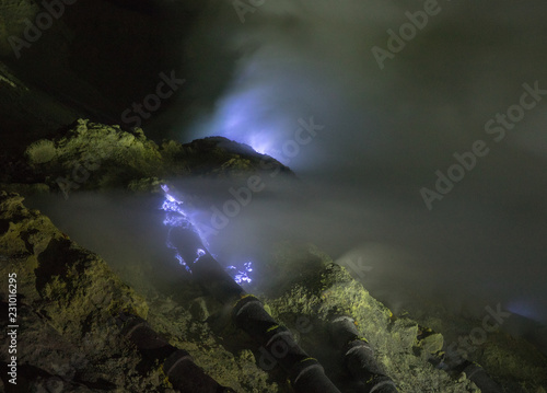 Blue Flame from the Mount Ijen sulfur mines inside the crater next to the emerald lake in East Java, Indonesia