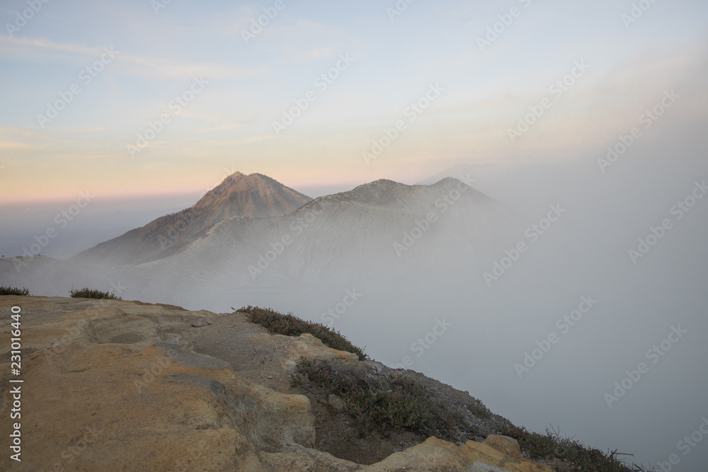 A smokey and active crater during sunrise at Mount Ijen volcano in East Java, Indonesia
