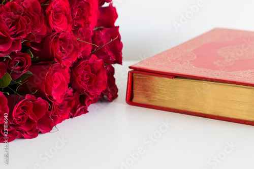 Koran and rosary beads on the white background with roses for Islamic concept. Holy book quran for Muslims holiday, Ramadan,blessed Friday message and three months.