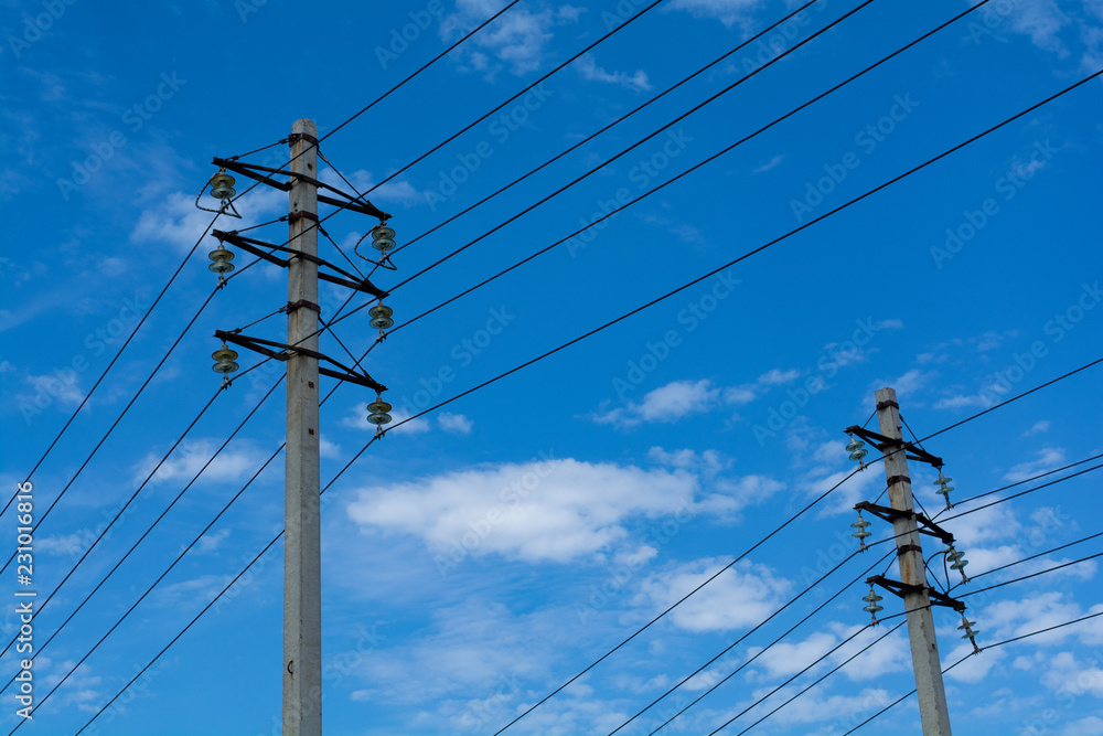 two pillars with wires against the blue sky with cirrus clouds two pillars with wires against the blue sky with cirrus clouds