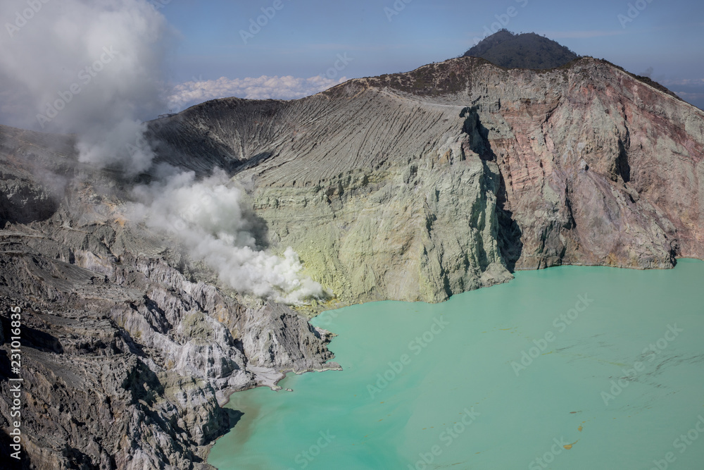 Stunning emerald sulfuric lake in the caldera of the Mount Ijen volcano in East Java, Indonesia