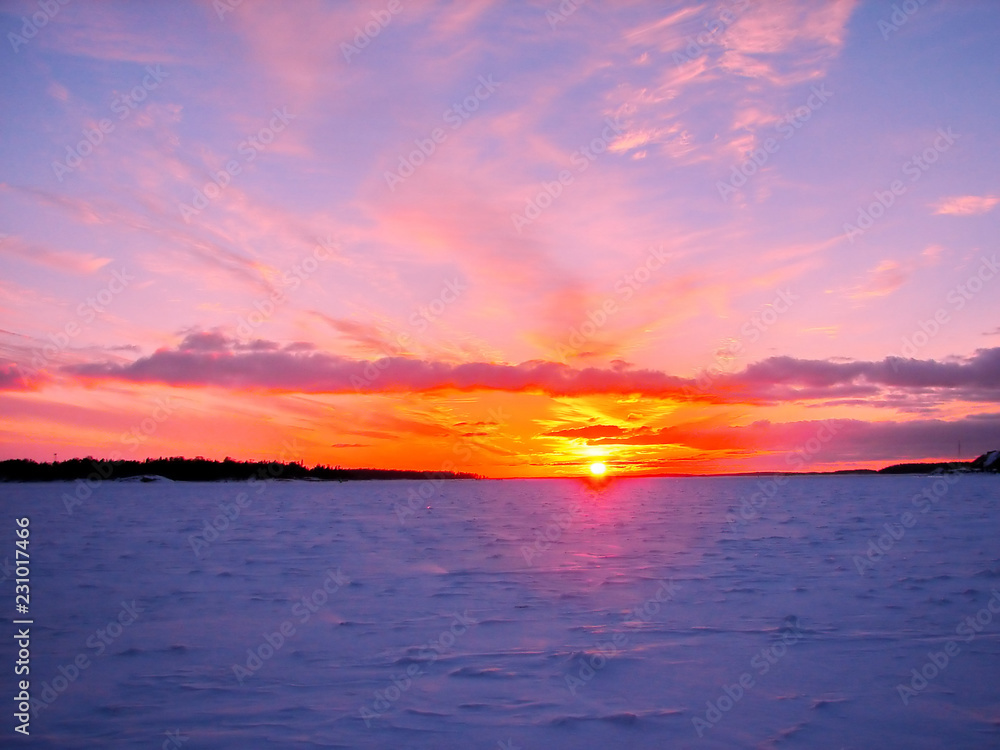 Winter sunset over frozen Baltic Sea in Finland