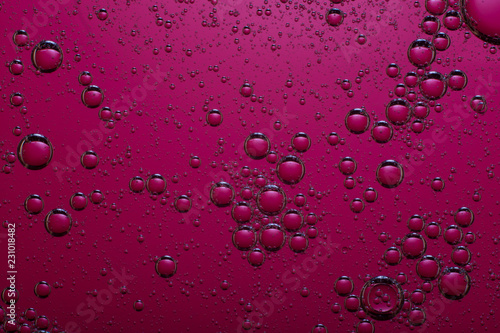 oil bubbles on a dark pink background