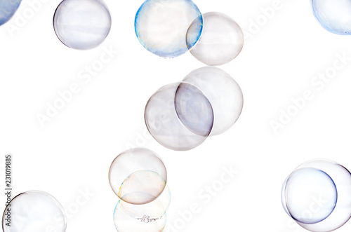 Multicolored soap bubbles close up on a white background