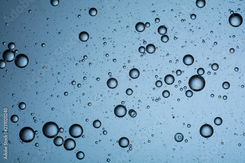 macro oil bubbles on the water. abstract light blue background