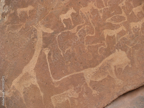 Ancient rock engravings, including depictions of animals such as giraffe, cattle, zebra, and a lion, at Twyfelfontein, Namibia, a UNESCO World Heritage Site