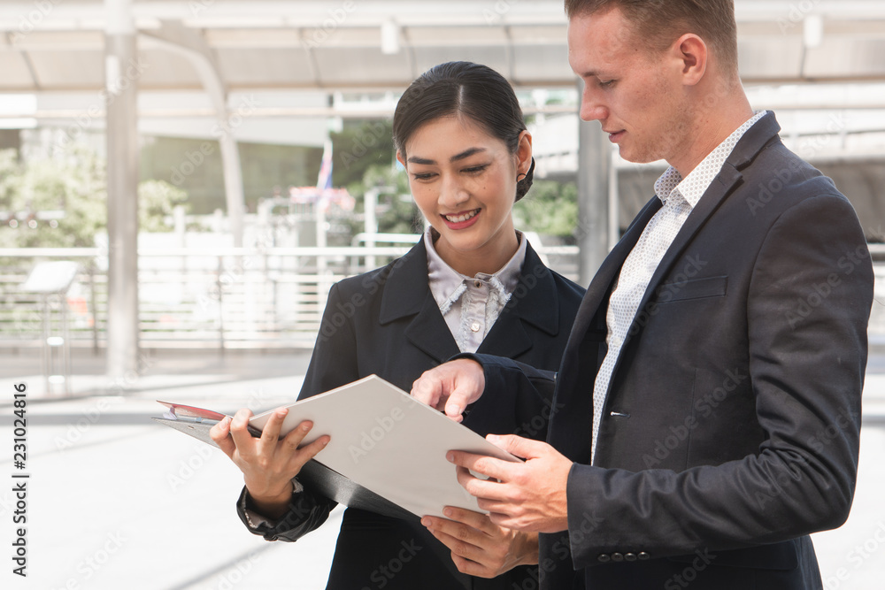 Asian young employee / staff asking for advice from manager / boss. Asian young employee / staff asking for advice from manager / boss.