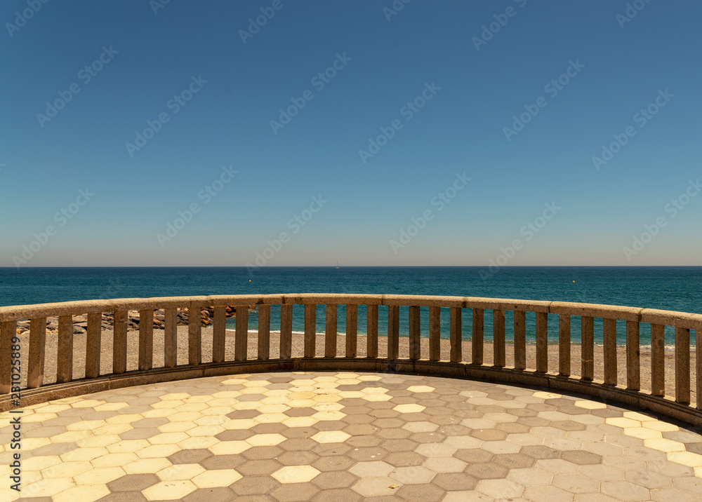 Antique balcony with sea view over background, view of the sea on a hot day