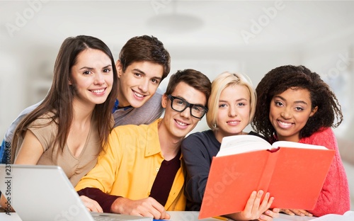 Group of students with laptop and book