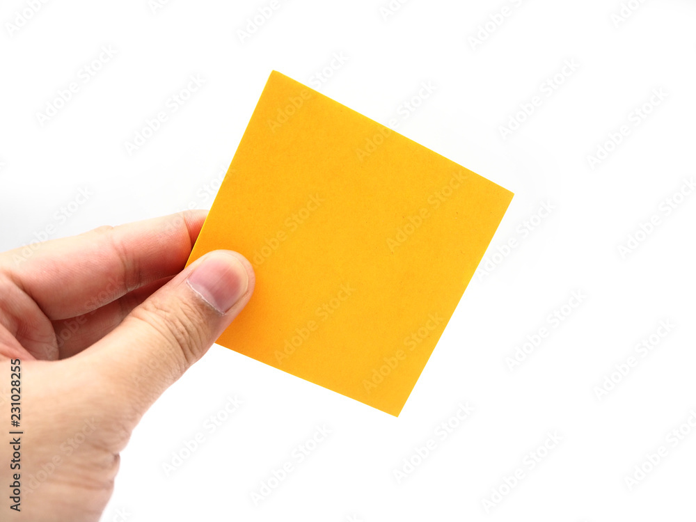 Hand holding an orange paper stick note isolated on a white background. Hand holding an orange paper stick note isolated on a white background.