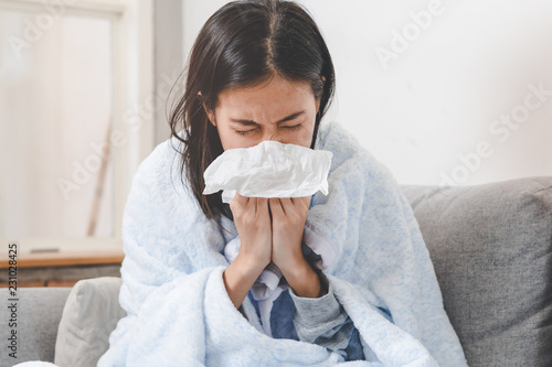 Fototapeta Sick day at home. Asian woman has runny and common cold.