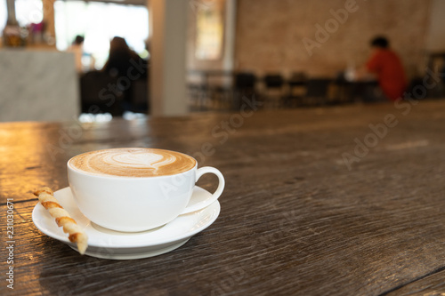 Coffee cup on table with blur background cafe