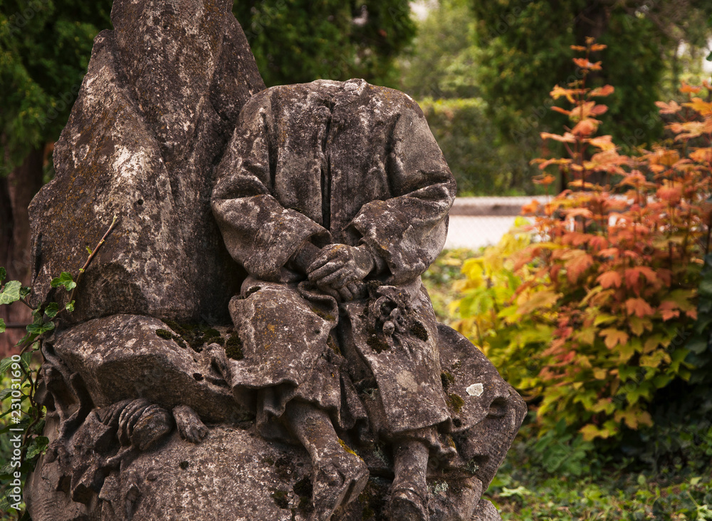 Old broken statue sitting boy, without head (concept death, eternity) Old broken statue sitting boy, without head (concept death, eternity)
