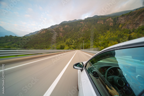 Car in motion blur driving in the Mountains