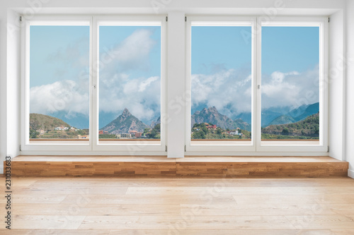  looking through window in modern apartment with wooden floor and panorama view on mountain landscape   -