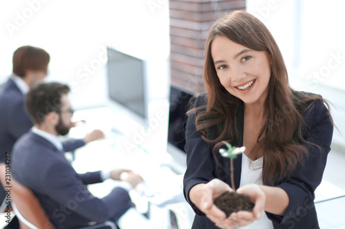 Wallpaper Mural female environmentalist showing fresh sprout Torontodigital.ca