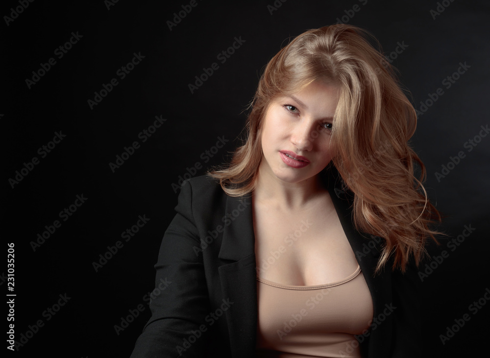 Portrait of beautiful woman with long curly blond hair on black background. Portrait of beautiful woman with long curly blond hair on black background.