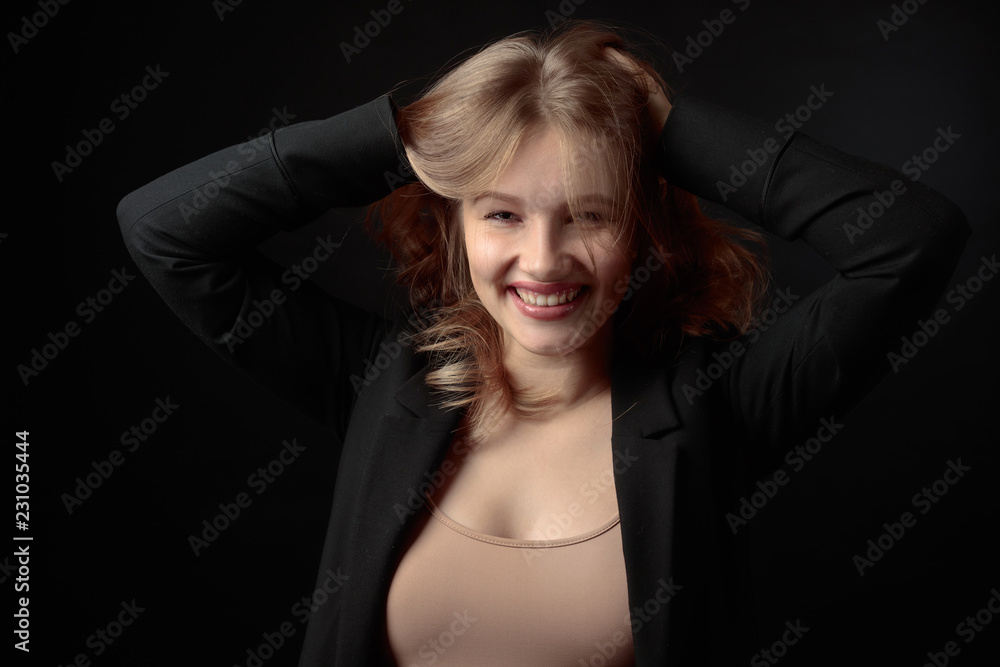 Young smiling woman with natural make-up in a black jacket. Young smiling woman with natural make-up in a black jacket.