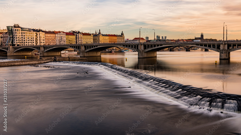 Obraz premium View from the river to Jirasek Bridge and the Vltava River. A sunny day at the Vltava river in Prague