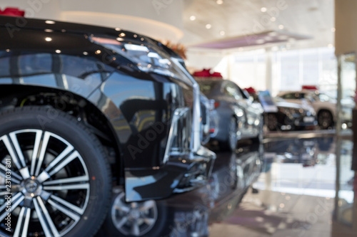 Car auto dealership.Themed blur background with bokeh effect. New cars at dealer showroom. © tikhomirovsergey