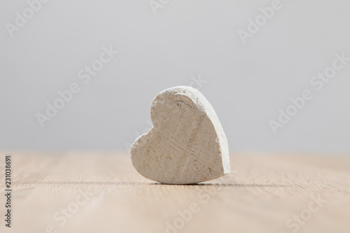 Wooden white heart on wooden table