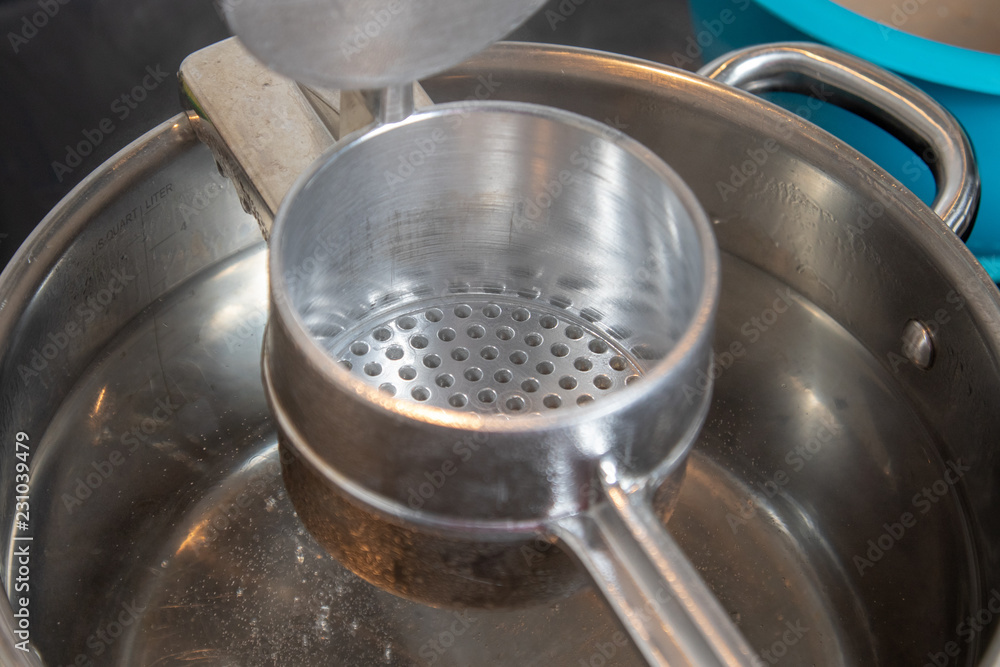 Close up of silver spaetzle ricer Close up of silver spaetzle ricer