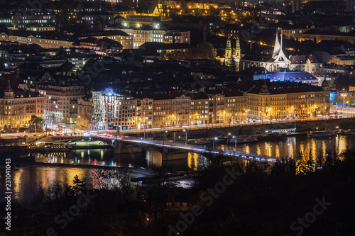 An aerial view of the old city of Prague with icons like the Dancing House, Emmaus Abbey, the Nusel Bridge. View from Petrin tower. photo