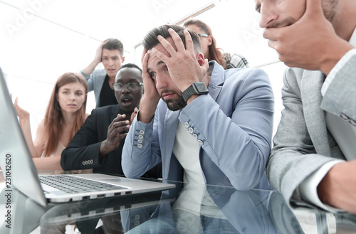 Billede på lærred businessmens looking stressed in front of a laptop