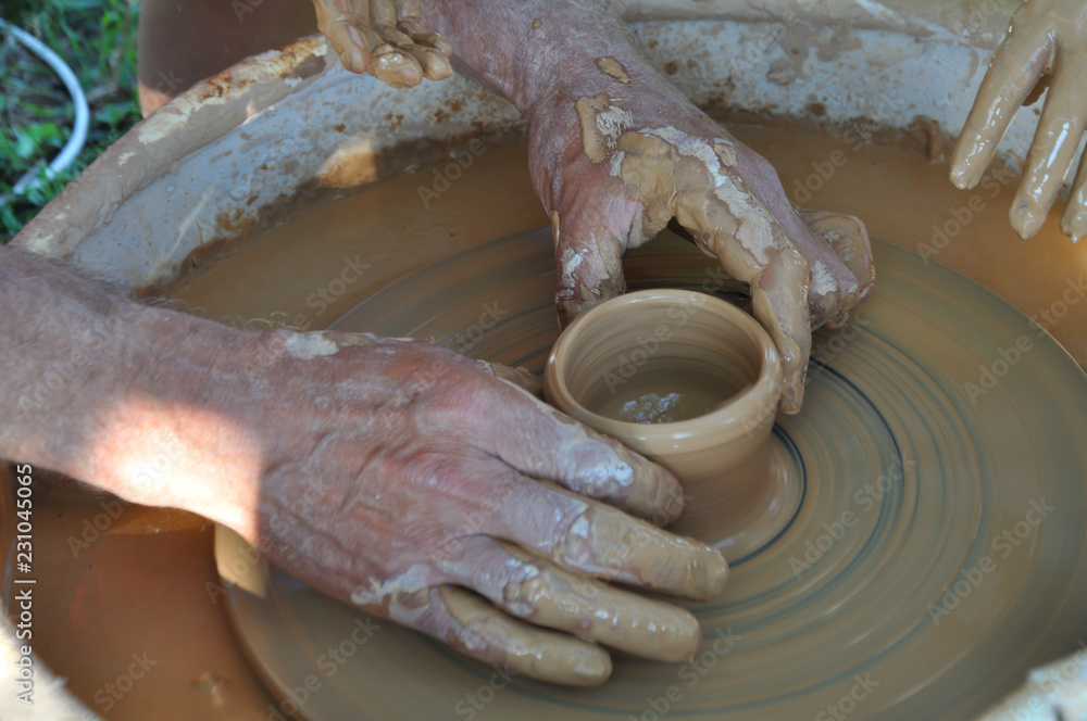 Potter teaches modeling pots and vases of clay on the Potter's wheel