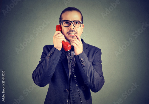 Confused man speaking on a phone
