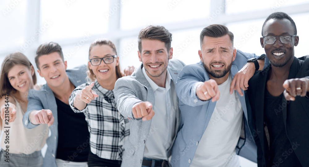 Obraz premium Group of people pointing at the camera and smiling - isolated