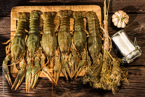Raw crayfish with beer on wooden background
