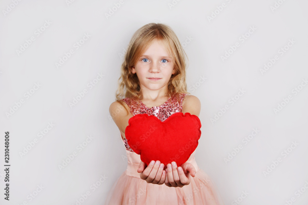7259782 beautiful blond girl with red heart on a white background. Child with a heart for Valentine's day 7259782 beautiful blond girl with red heart on a white background. Child with a heart for Valentine's day