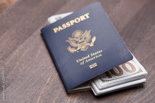 Passport of United States of American. Traveling passport. closeup of an american passport and money on a wooden table. travel concept.