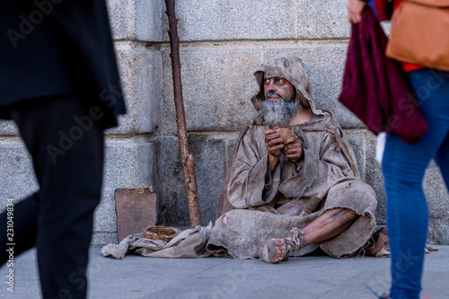Valokuva Ragged beggar begging on the street