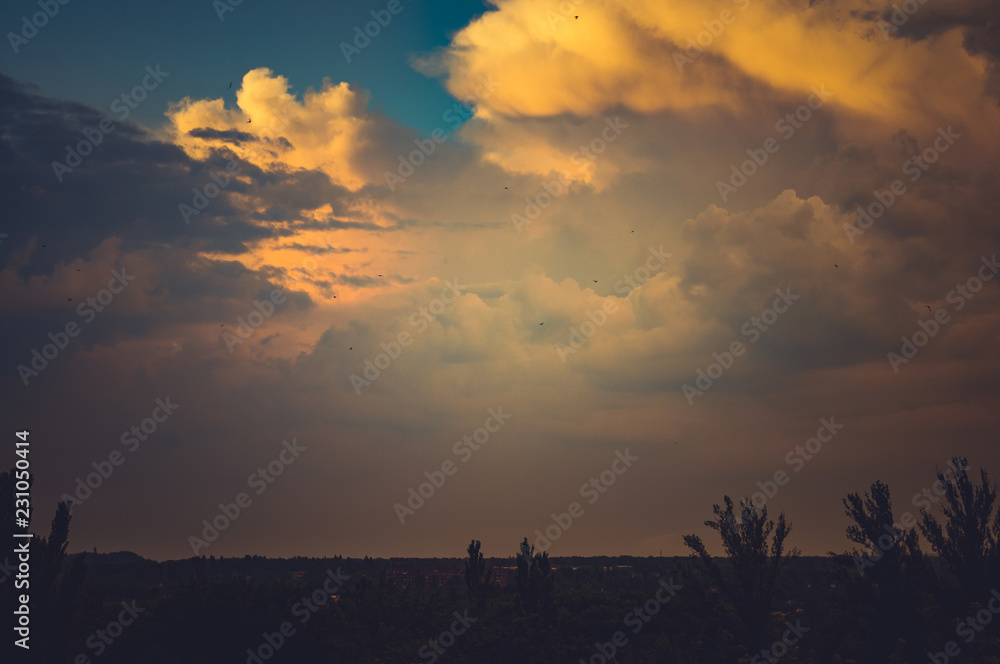Fototapeta premium Landscape with dramatic light - beautiful golden sunset with saturated sky and clouds.