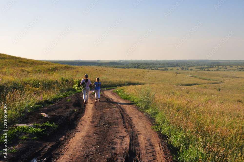 Obraz premium The road among green fields and blue sky