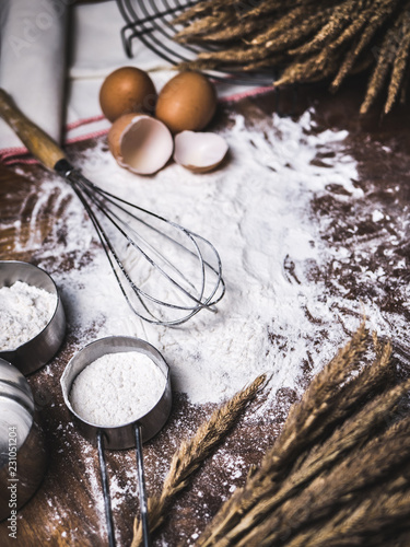 Pastry Baking Accessories Bakery Background with flour and whisk. Ingredients for the preparation of bakery products.