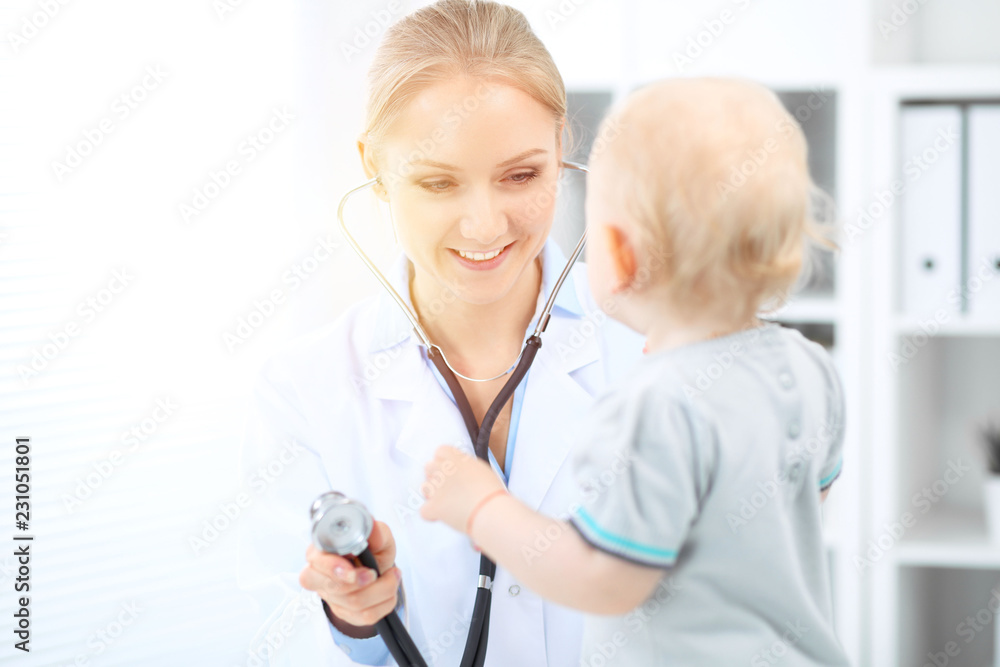Doctor and patient in hospital. Little girl is being examined by pediatrician with stethoscope. Medicine and health care Doctor and patient in hospital. Little girl is being examined by pediatrician with stethoscope. Medicine and health care