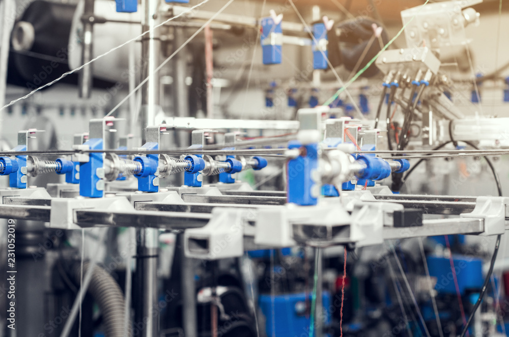 Details of knitting machines in the factory, springs, threads, guide elements Details of knitting machines in the factory, springs, threads, guide elements