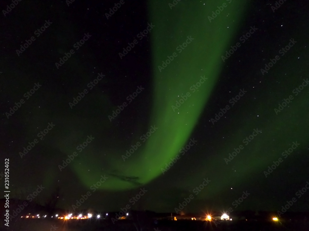 The Aurora Borealis flashing on the Early Winter Night Sky of Reykjahlid, the Northern Part of Iceland 