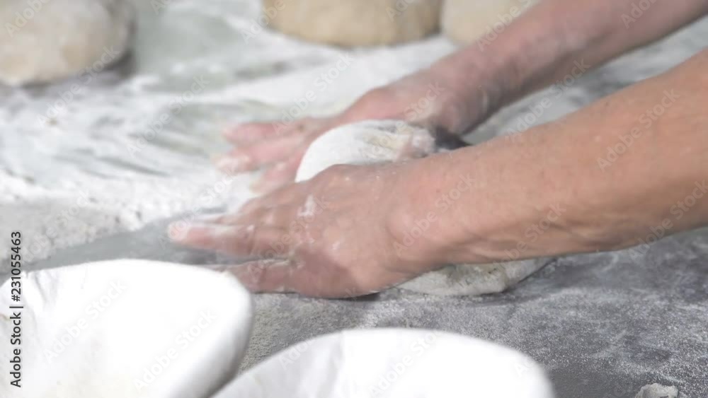 Baker packs dough for bread Baker packs dough for bread